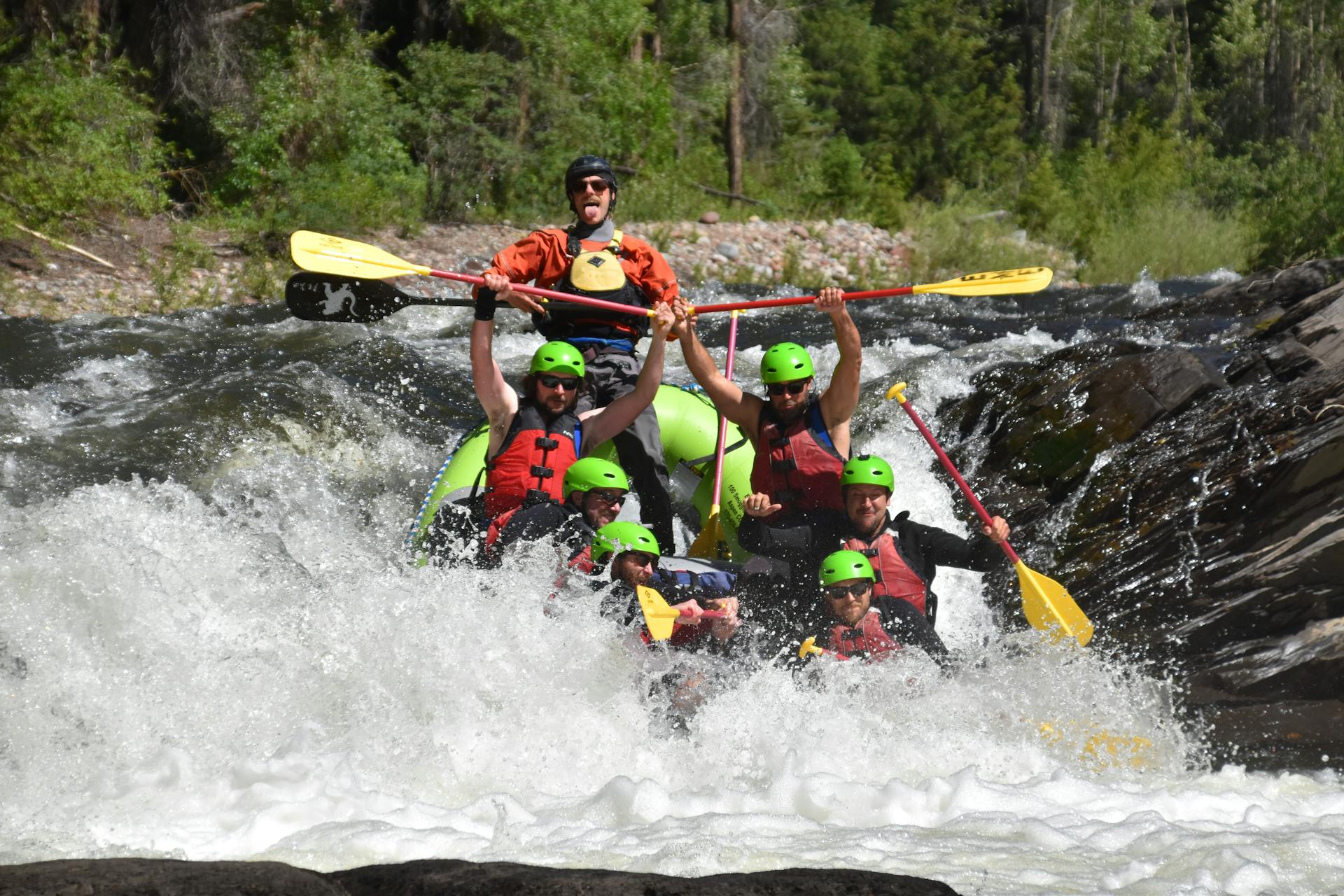 A group of people whitewater rafting
