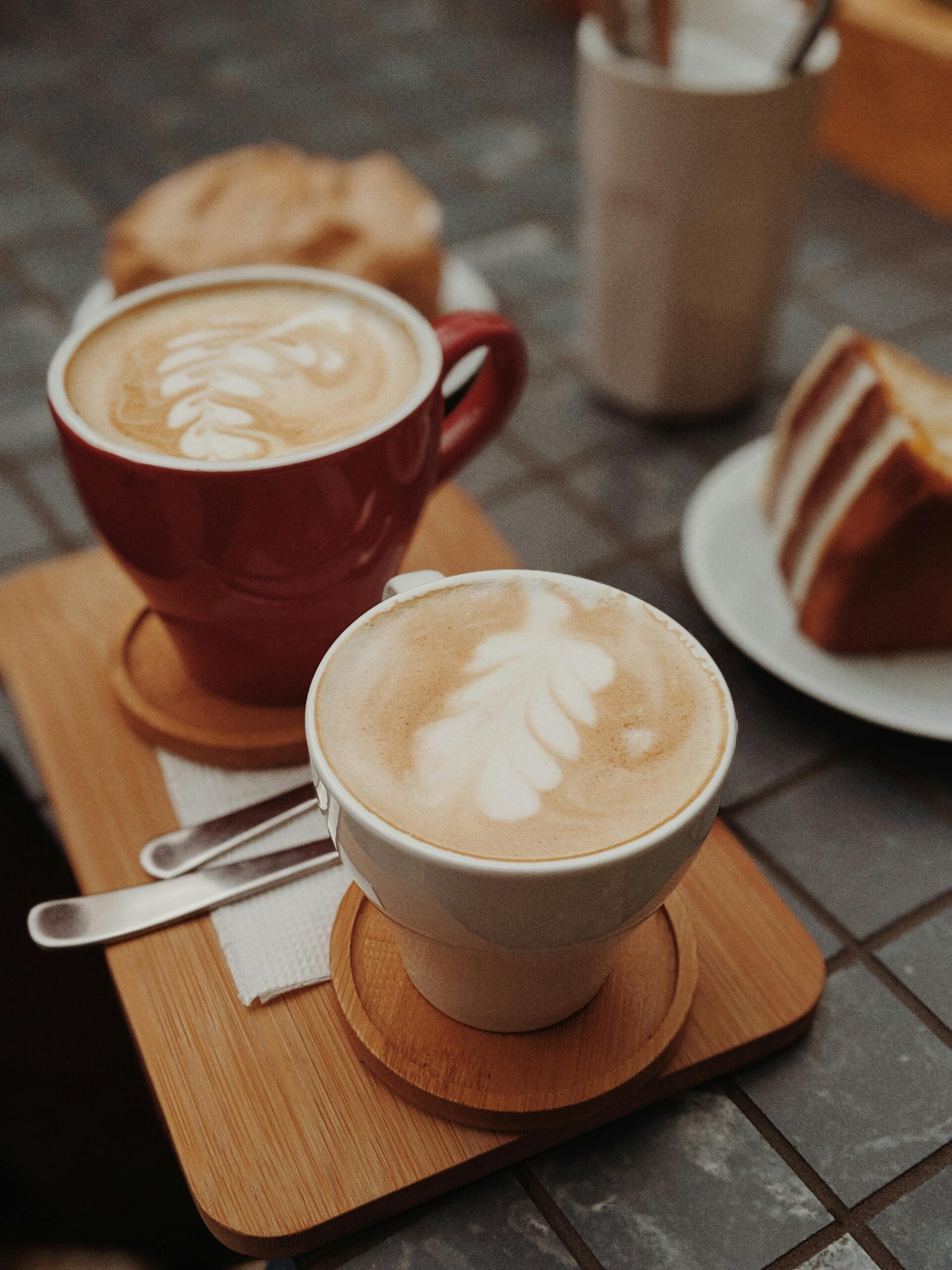 Brown coffee with latte art complemented with delicious cake and bread.