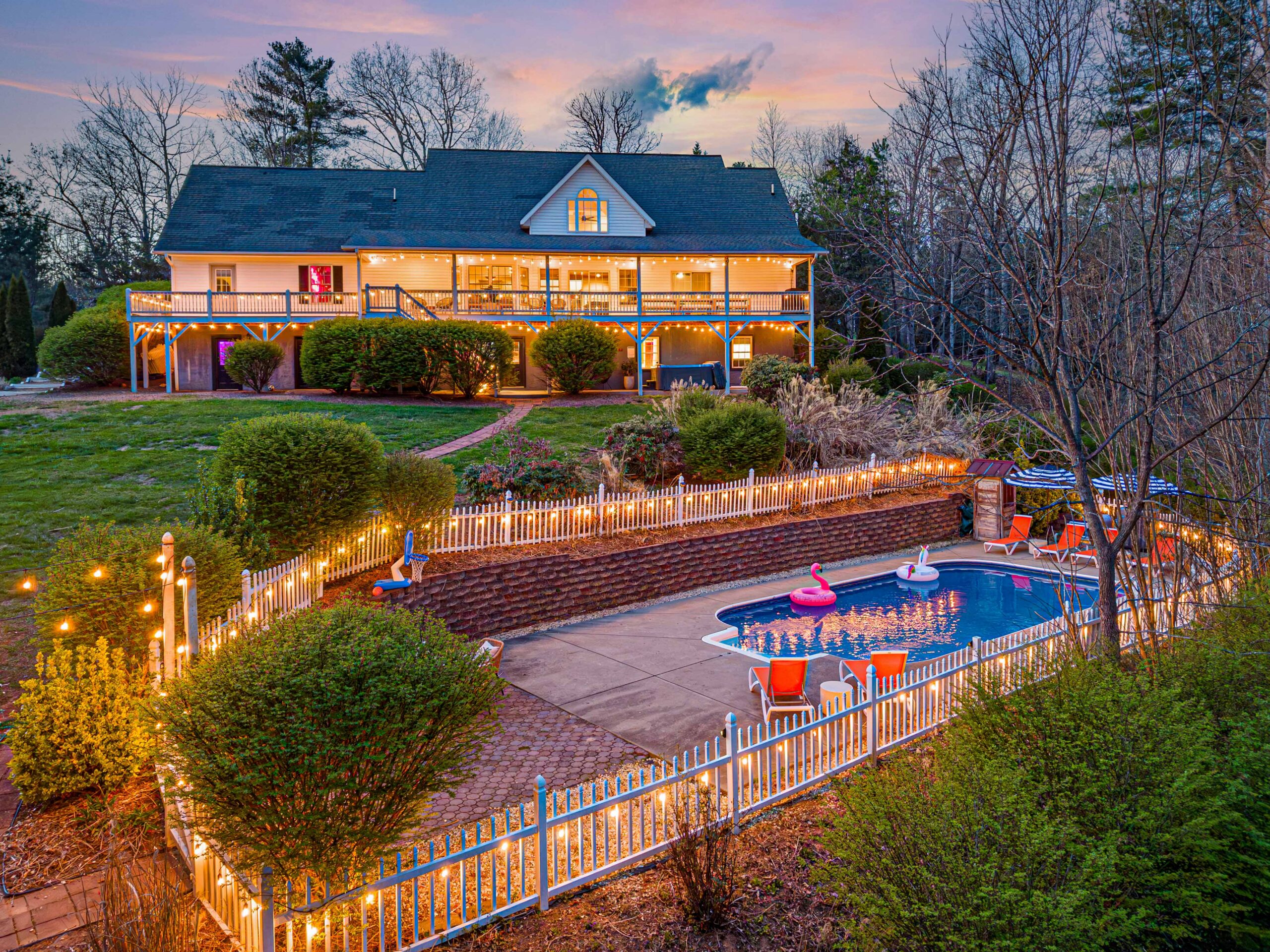 Asheville vacation rental backyard with a pool and string lights.