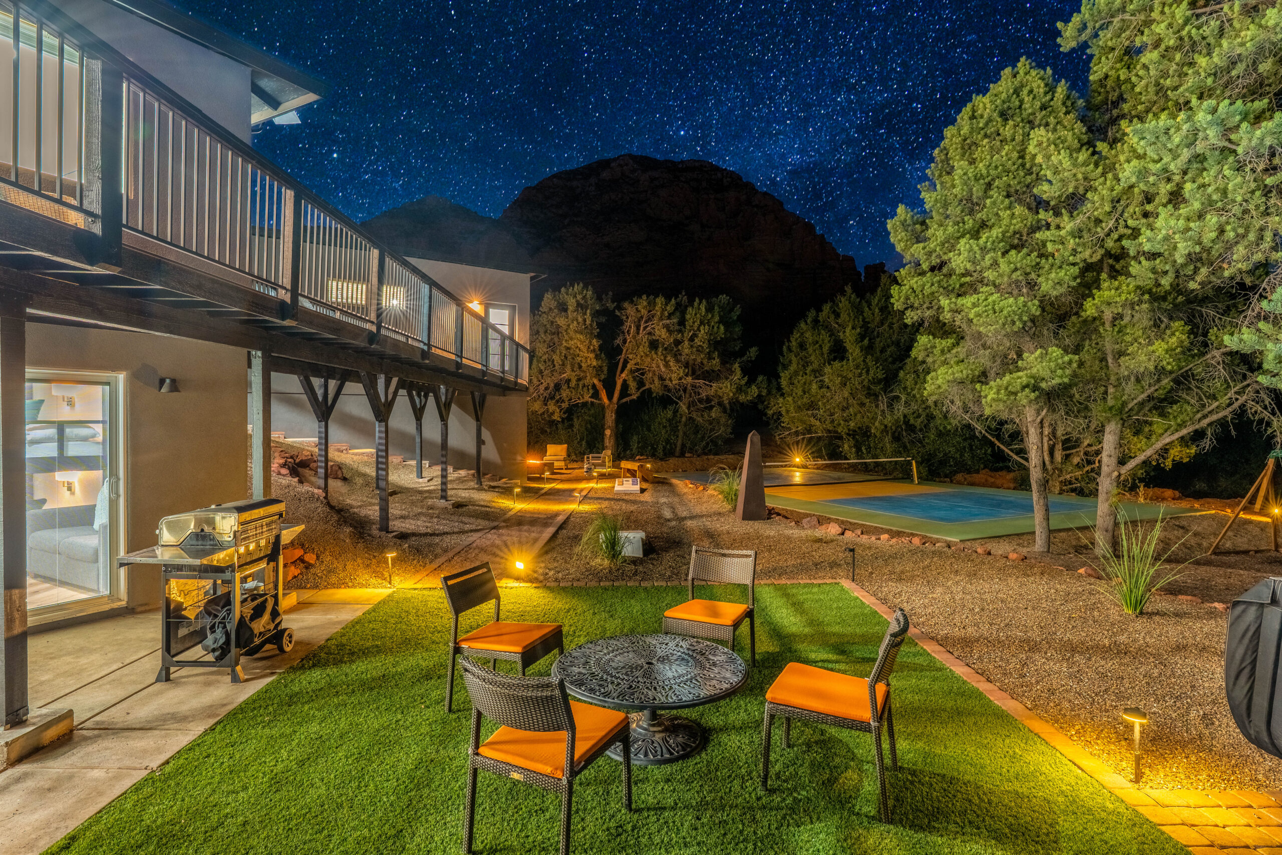 View of the stars from the backyard of a Sedona vacation rental with pickleball court, outdoor dining and grill.