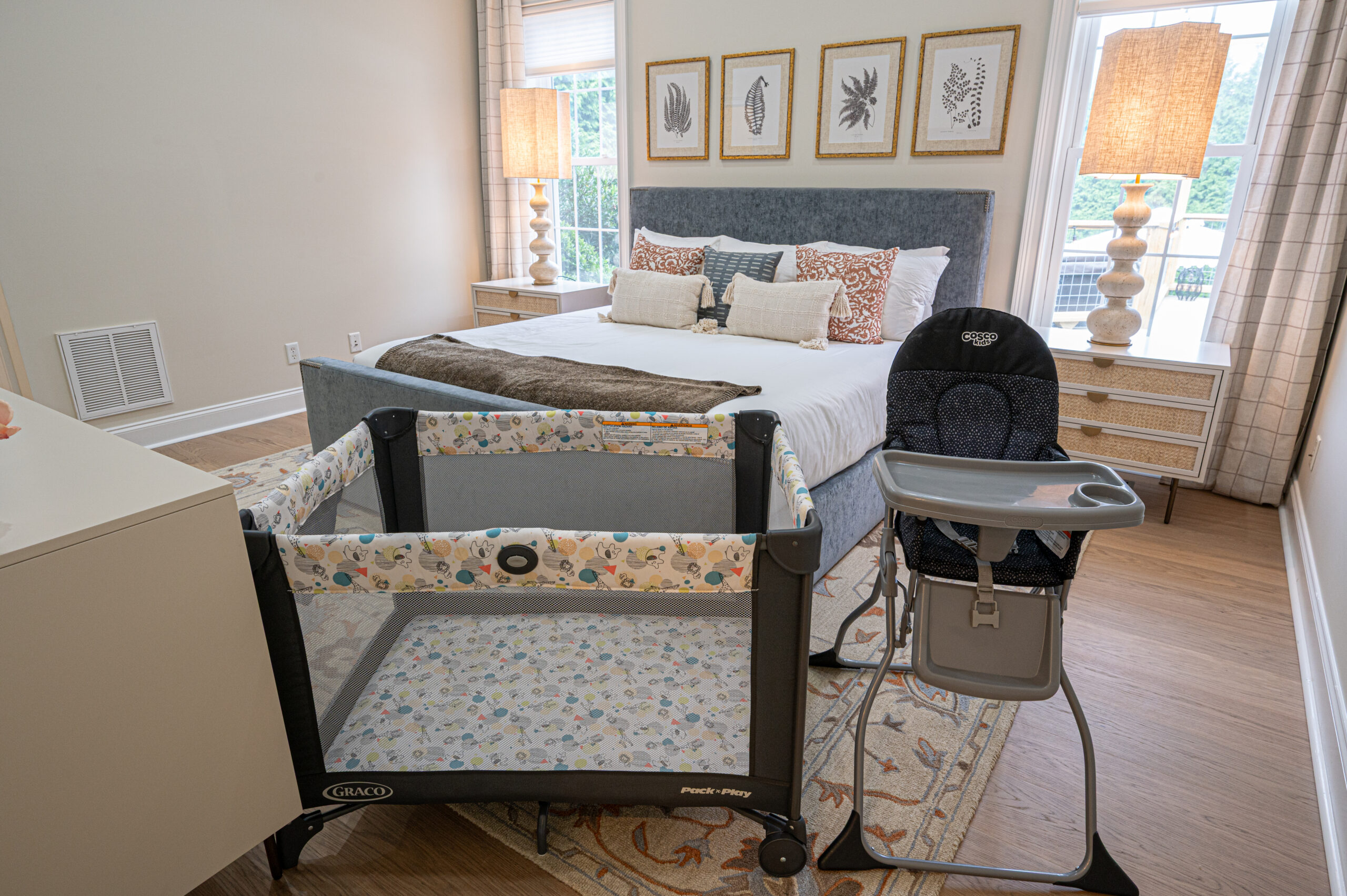 Travel crib and high chair inside the bedroom of an Asheville vacation rental.