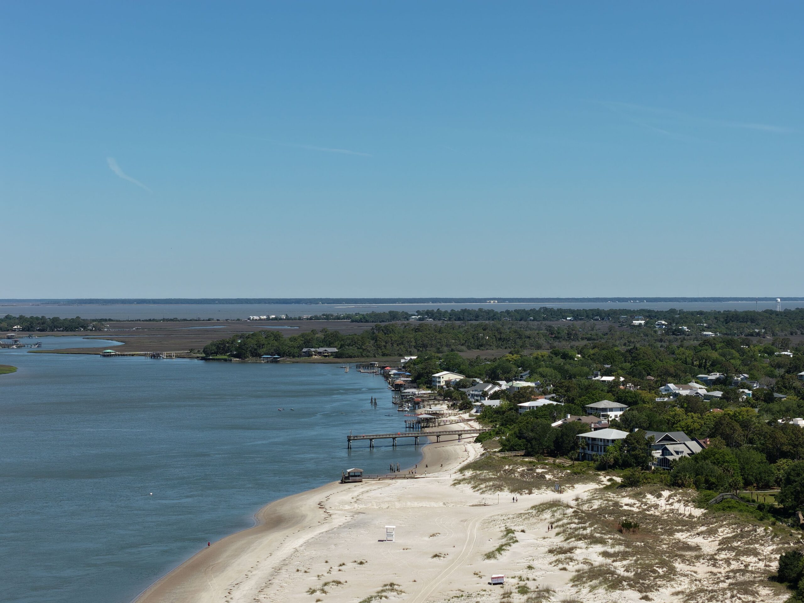 Drone shot of Tybee Island beach, wooden docks, and marsh waterways near Savannah Georgia