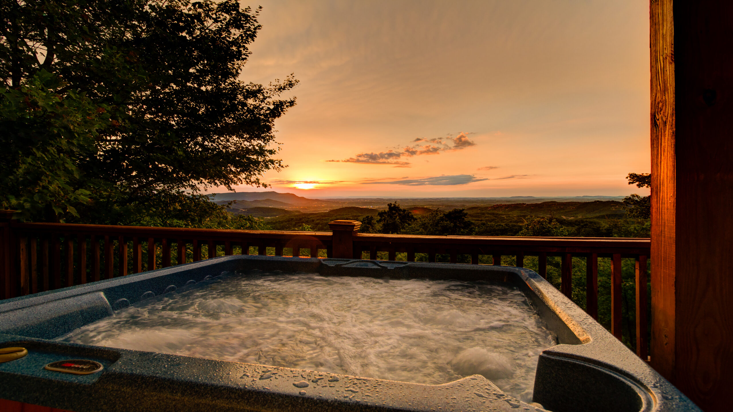 Sunset Smoky Mountain views from a hot tub of a vacation cabin rental.