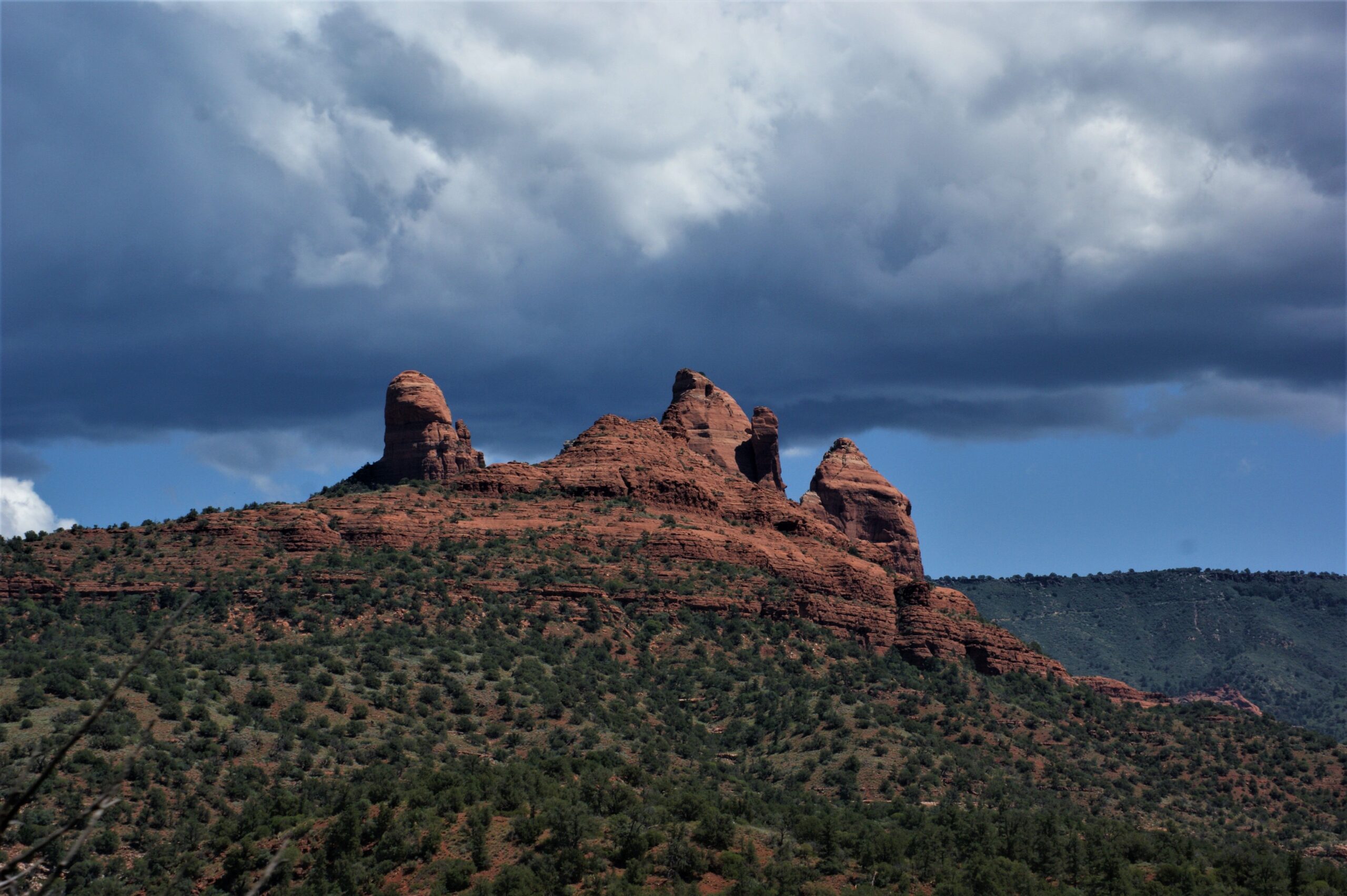 Snoopy Rock red rock formation under a cloudy sky in Sedona, Arizona